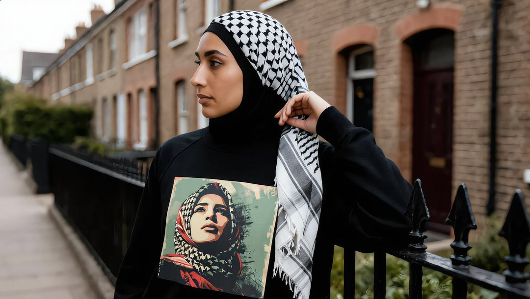 Woman in a Palestine Hope sweatshirt and keffiyeh scarf by a London terraced street
