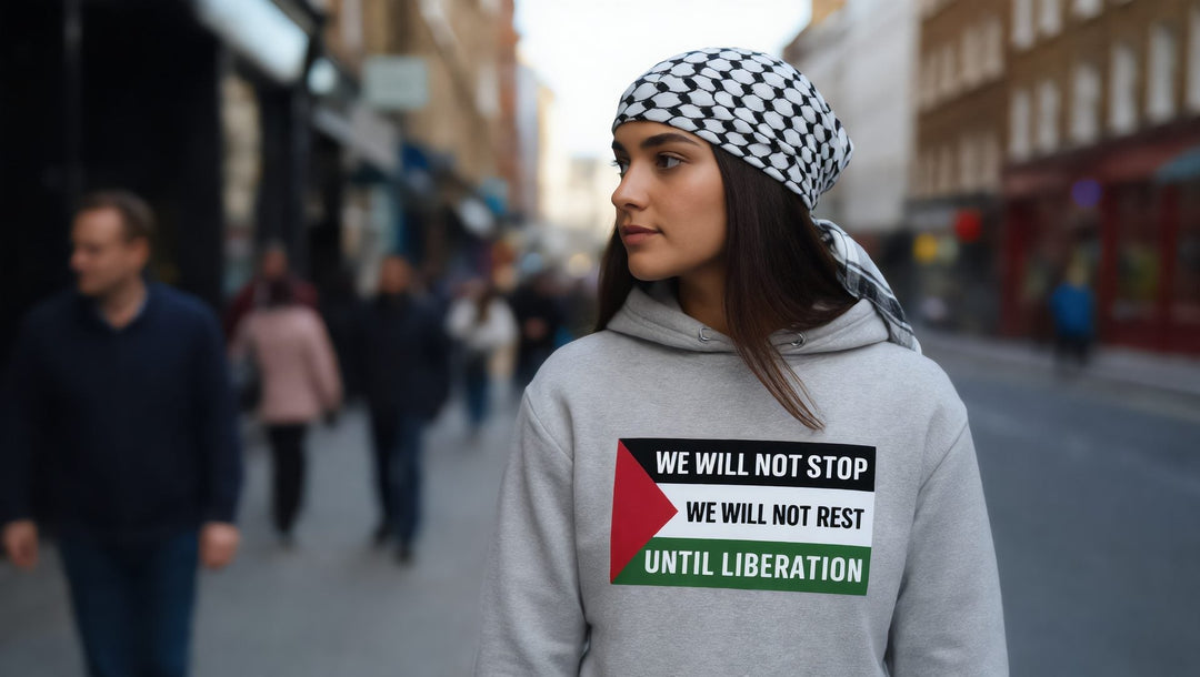 Woman in a grey We Will Not Stop hoodie on a street near Columbia Road, London