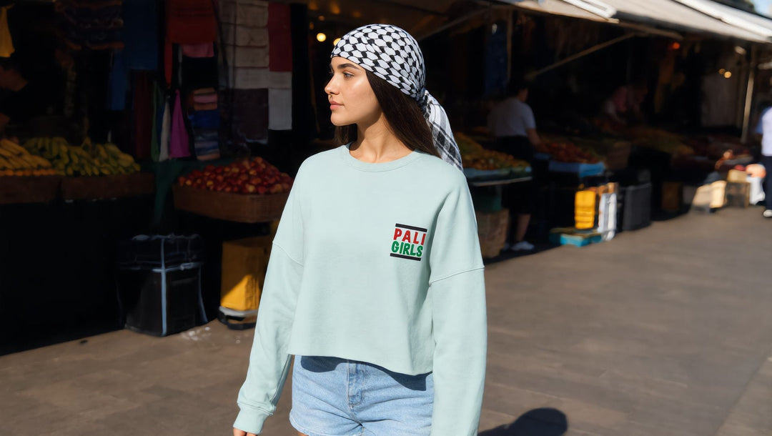 Woman in a Pali Girls embroidered crop sweatshirt on Deptford High Street in summer