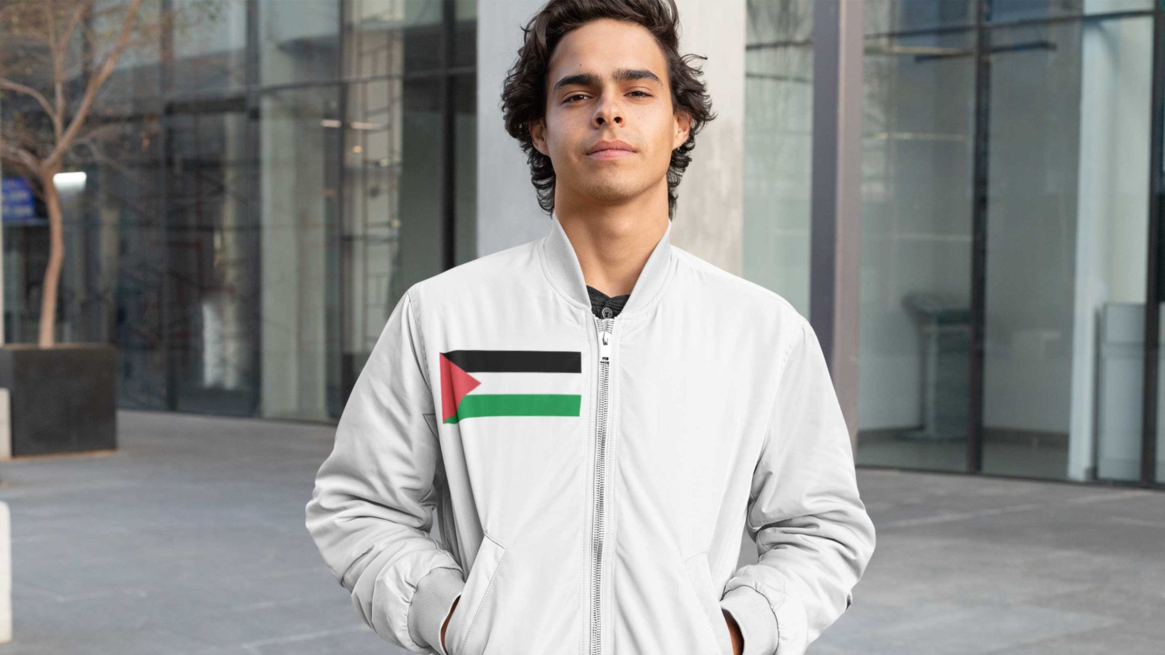 men wearing a bomber jacket with Palestine flag