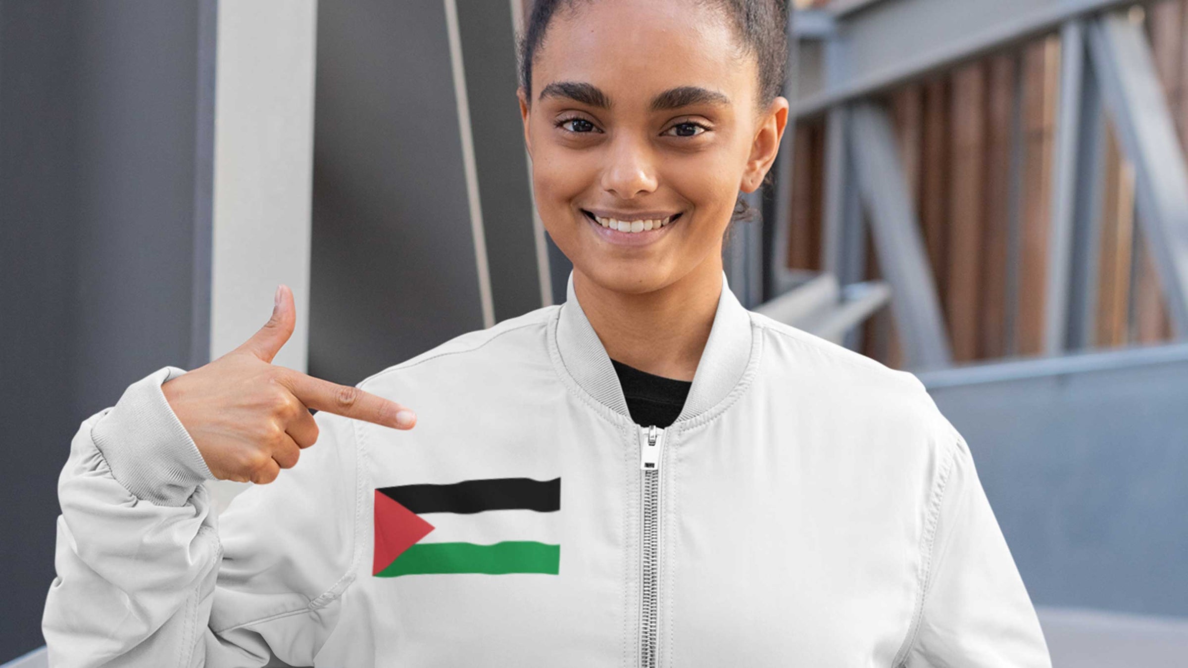 women wearing a bomber jacket with Palestine flag