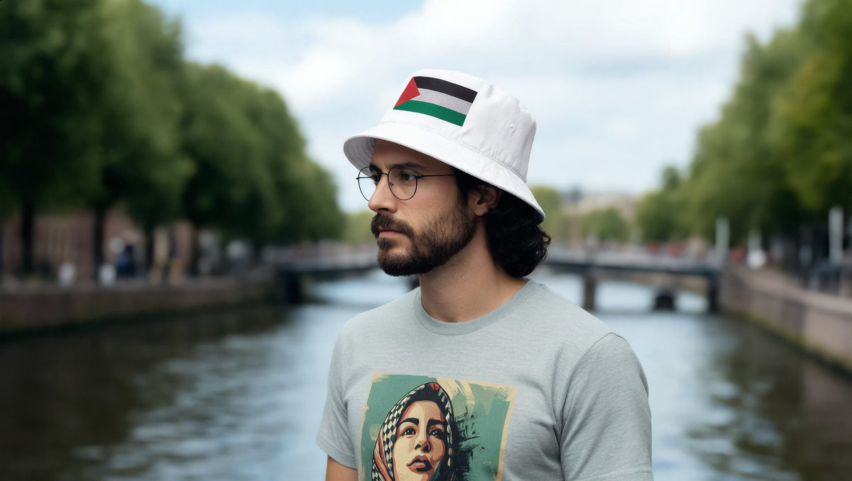 Man wearing a Palestine Flag Organic bucket hat on the South Bank walkway by the Thames, London