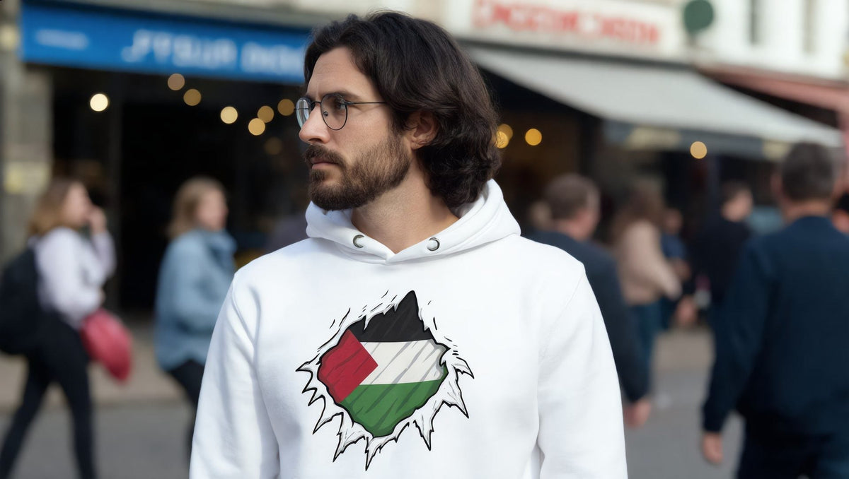 Man wearing a white Palestine Hero hoodie on the Strand, London