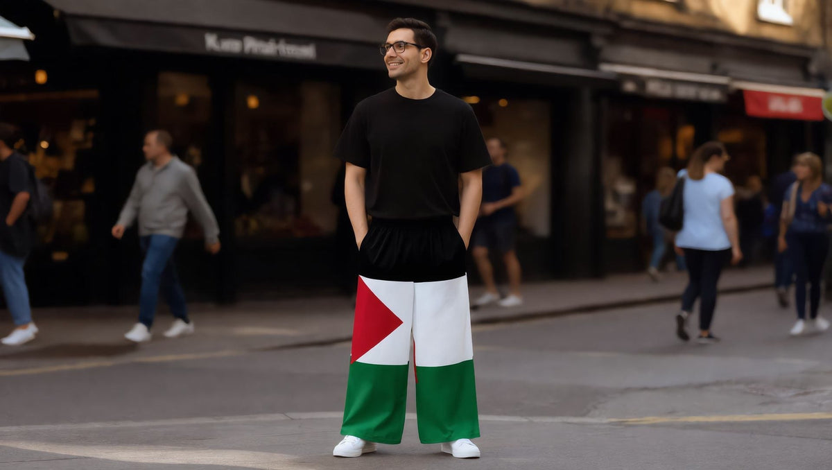 Man wearing Palestine flag wide-leg trousers on Camden High Street, London