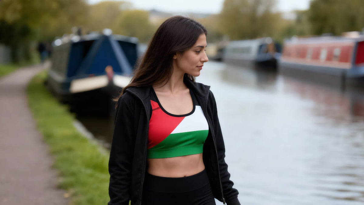 Woman wearing a Palestine flag padded sports bra under an open jacket on the Regent's Canal towpath, London
